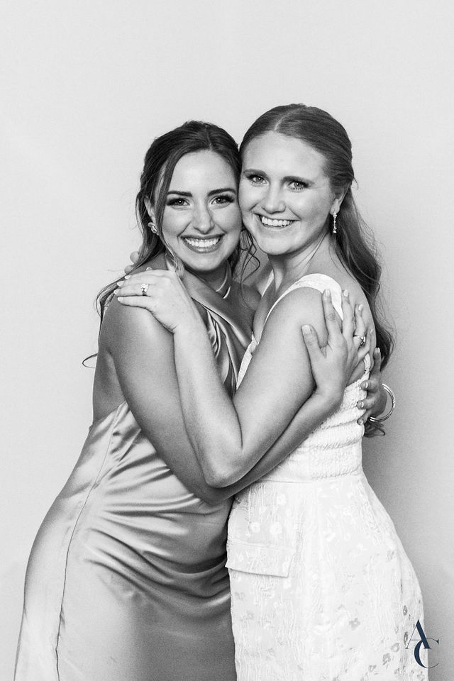 Two guests embracing for a portrait at the reception