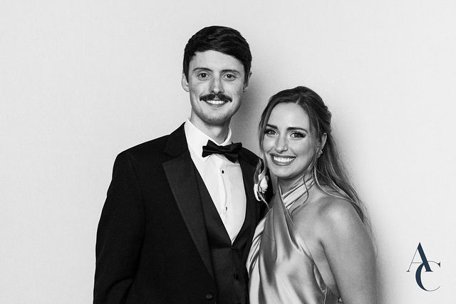 Groom and bride laughing in a studio-lit reception portrait