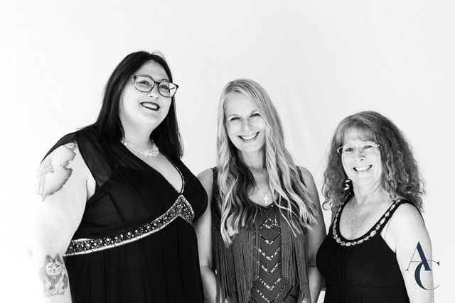 Three guests laughing together during a gala portrait