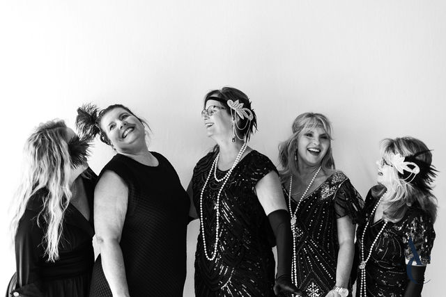 Gala guests in vintage dress posing as a group