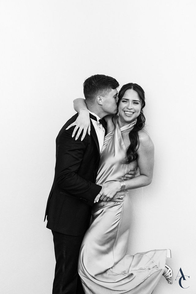 Couple leaning into each other during a reception portrait