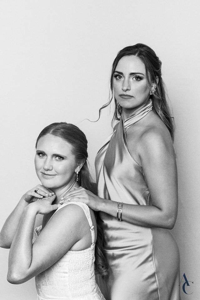 Two friends posed one behind the other for a studio portrait
