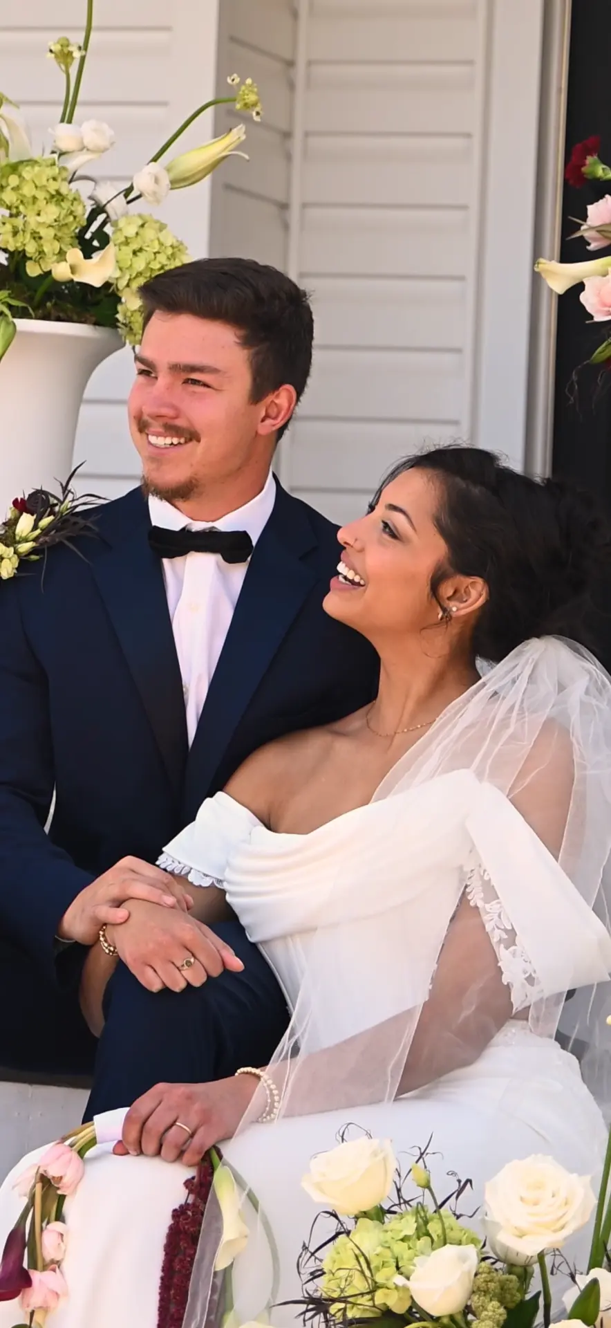 Bride and groom laughing together during their wedding celebration