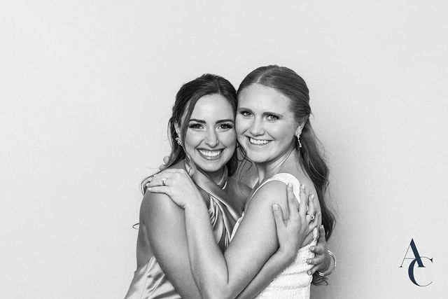 Two guests hugging and smiling for the camera