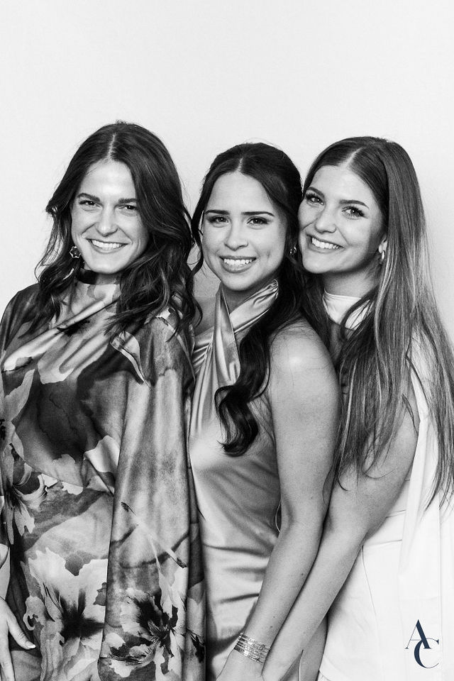 Three bridesmaids posing together for a black and white portrait